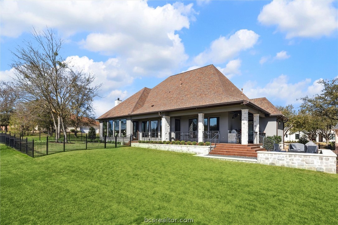 5202 Bourrone Court Bryan, TX 77802 - Photo 39 of 43 Back of home with iron fencing