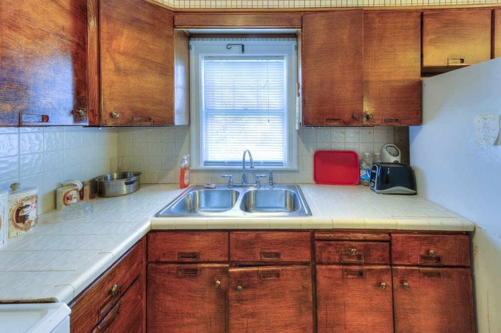 3 Longfellow Road Worcester, MA 01602 - Photo 18 of 33 a kitchen with a sink cabinets and a window