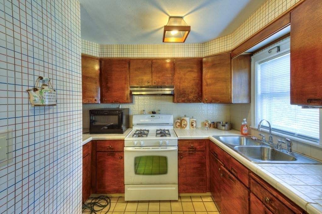 3 Longfellow Road Worcester, MA 01602 - Photo 20 of 33 a kitchen with a sink a stove cabinets and a wooden floor