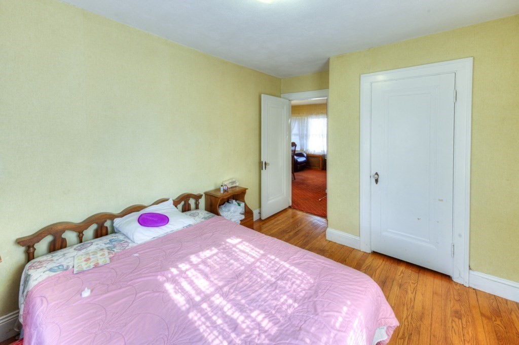 3 Longfellow Road Worcester, MA 01602 - Photo 26 of 33 a bedroom with a bed and wooden floor