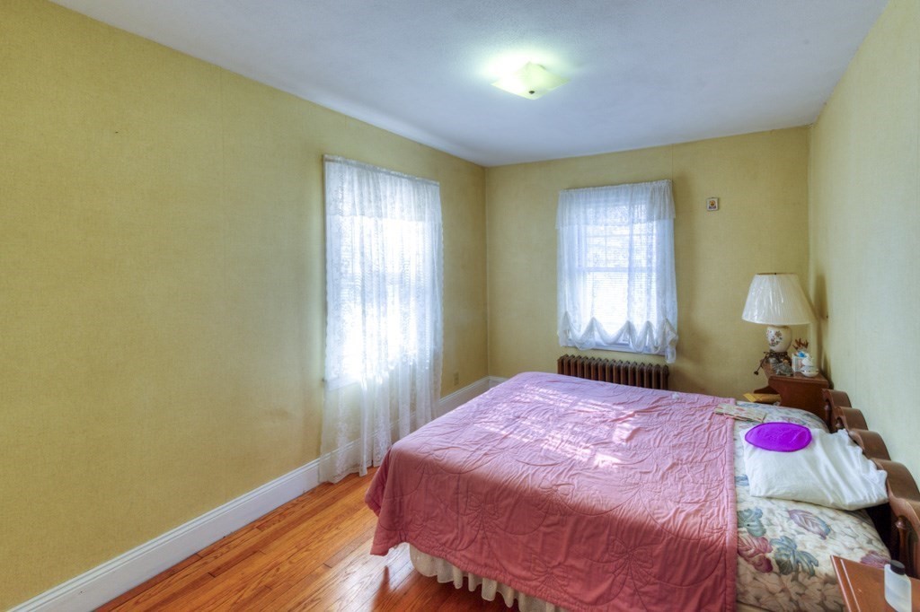 3 Longfellow Road Worcester, MA 01602 - Photo 28 of 33 a bedroom with a bed and wooden floor