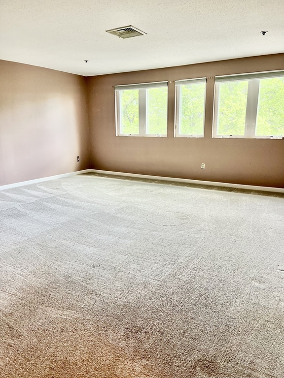 38 Dunham Road, Unit 303 Beverly, MA 01915 - Photo 5 of 12 an empty room with a window