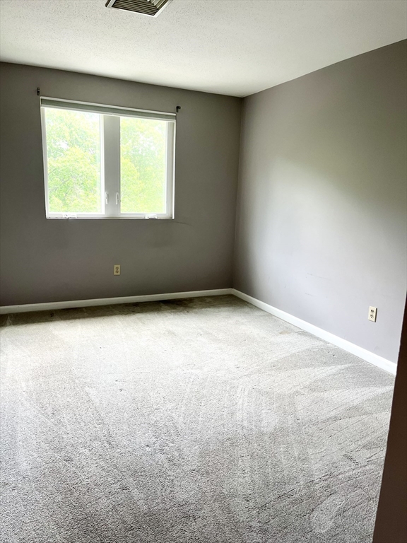 38 Dunham Road, Unit 303 Beverly, MA 01915 - Photo 9 of 12 an empty room with a window