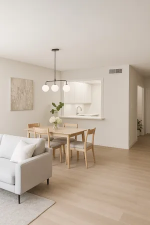 a living room with furniture a chandelier and a dining table