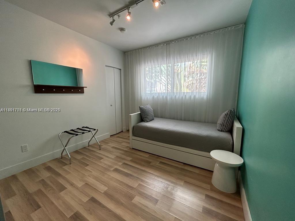 1816 Meridian Avenue, Unit 18 Miami Beach, FL 33139 - Photo 15 of 19 a living room with furniture and a flat screen tv