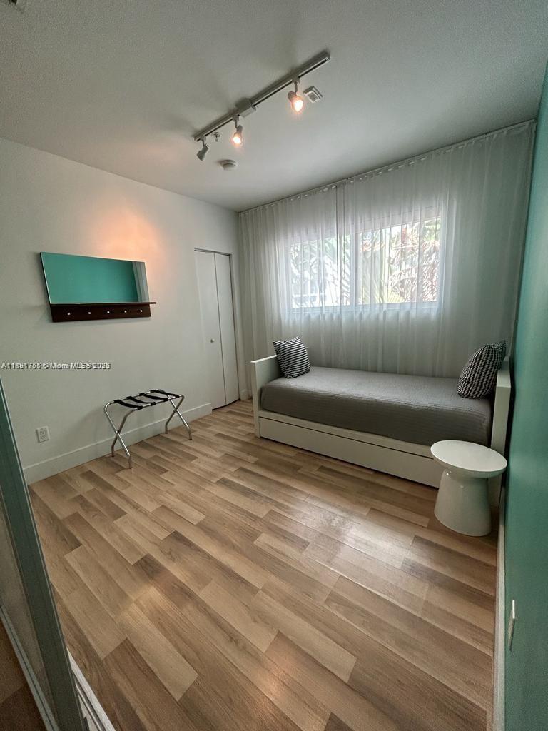 1816 Meridian Avenue, Unit 18 Miami Beach, FL 33139 - Photo 16 of 19 a living room with furniture and a flat screen tv