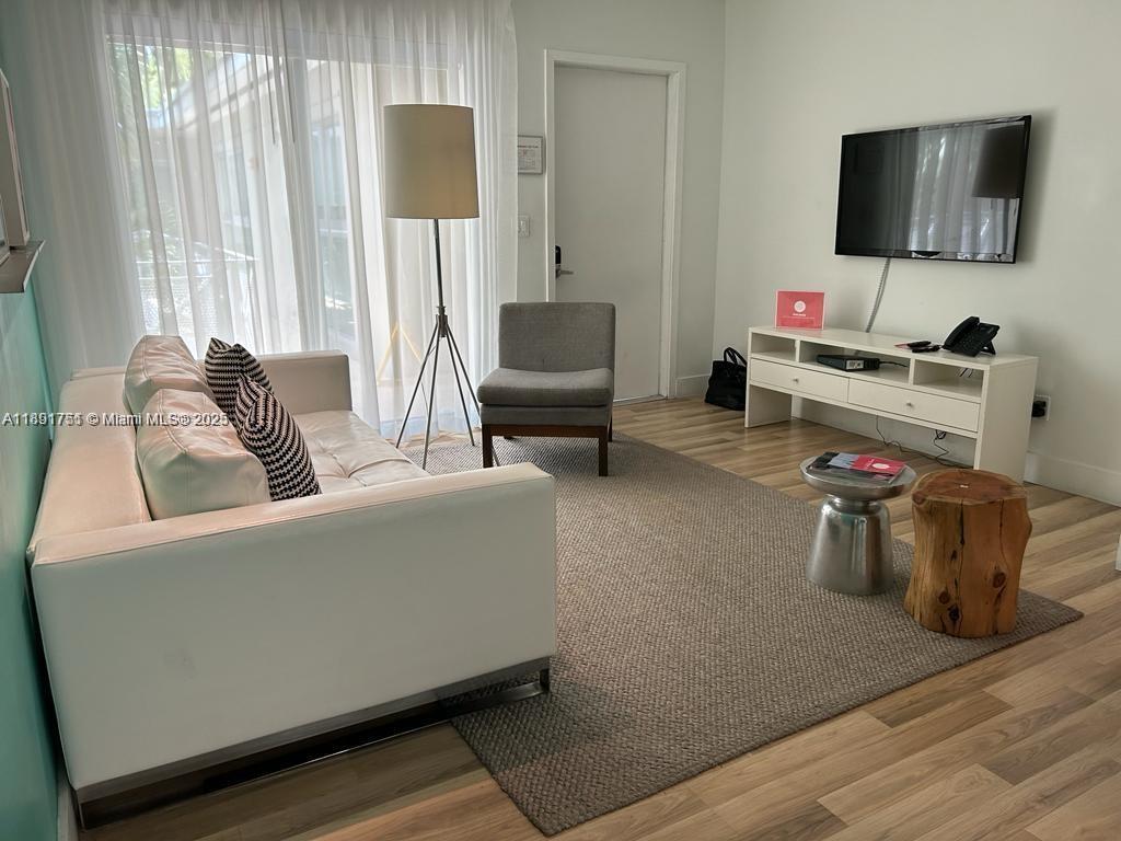 1816 Meridian Avenue, Unit 18 Miami Beach, FL 33139 - Photo 4 of 19 a living room with furniture and a flat screen tv