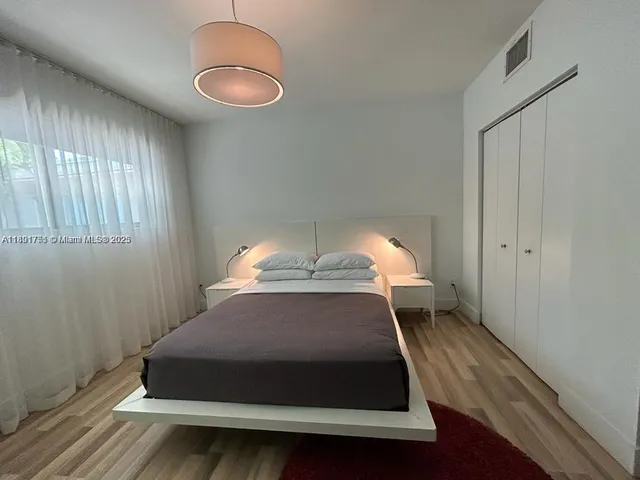 a room with a bed and window