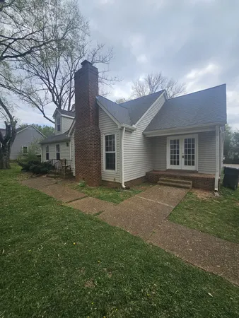 a large kitchen with stainless steel appliances a large counter top a stove and a refrigerator