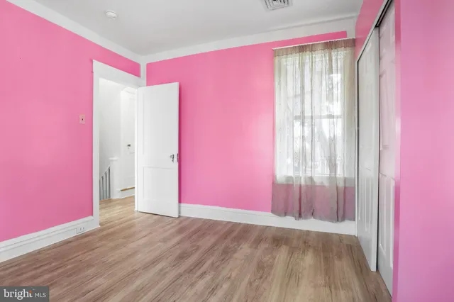 a view of a room with wooden floor and windows