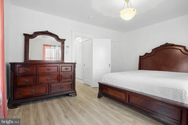 a bedroom with a bed and a dresser