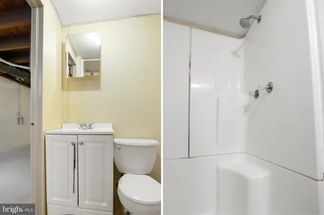 a bathroom with a granite countertop toilet a sink and a mirror