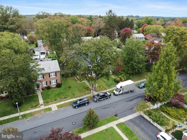 an aerial view of a house with a yard basket ball court and outdoor seating