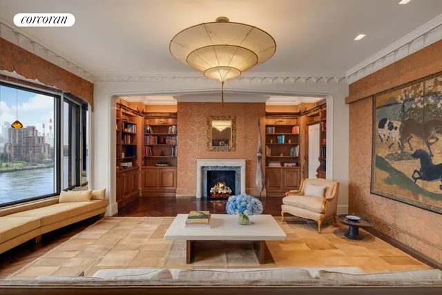 a living room with a large window and a rug