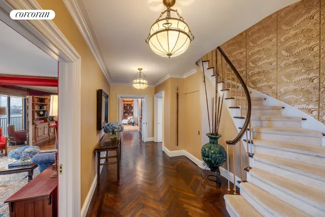 a living room with furniture a piano and a bookshelf