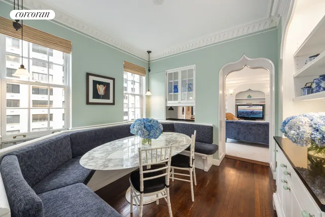 a large white kitchen with lots of counter space a sink and appliances