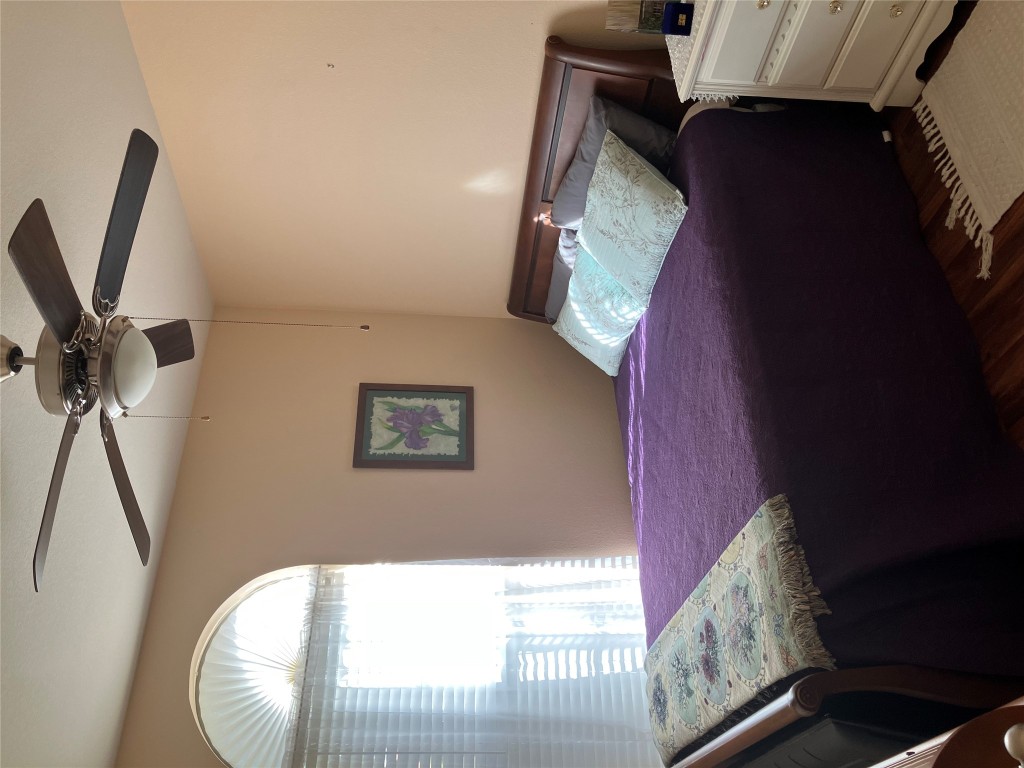 250 Engineers Pass Jarrell, TX 76537 - Photo 20 of 22 a bedroom with a bed and a chandelier