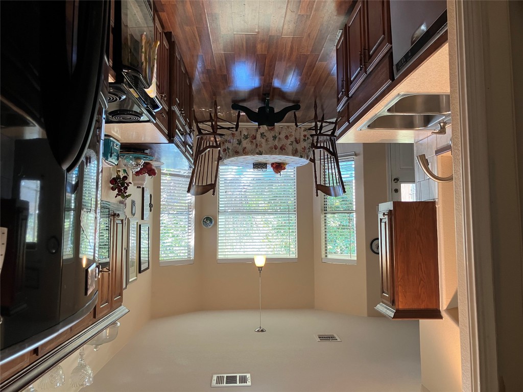 250 Engineers Pass Jarrell, TX 76537 - Photo 6 of 22 a kitchen with a table chairs stove and wooden floor