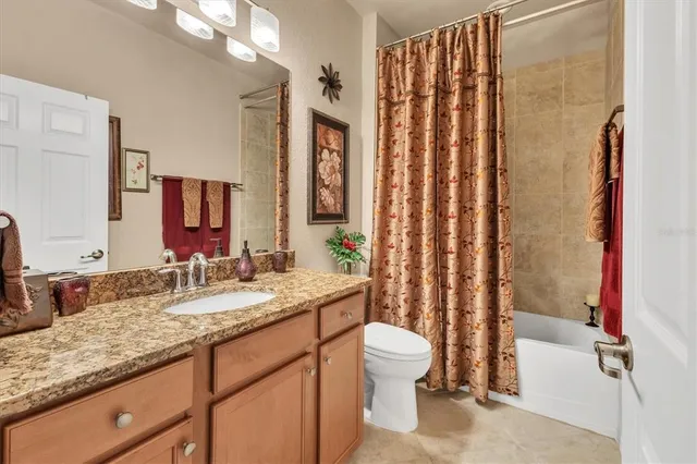 a view of a house with a yard and potted plants