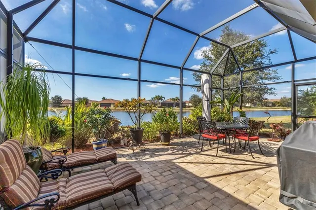 a living room with furniture pool table and windows