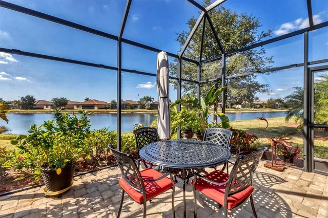 a view of a dining room with furniture a chandelier and wooden floor