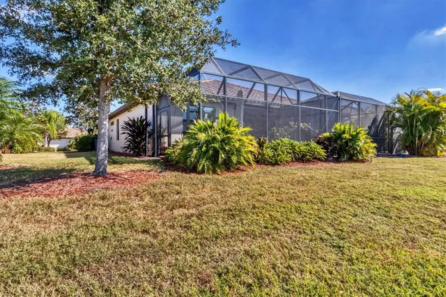 a view of a house with swimming pool and sitting area