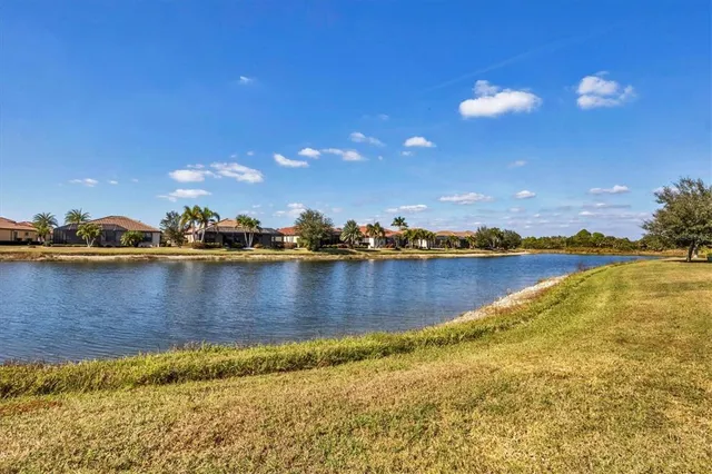 an aerial view of a house with outdoor space and lake view