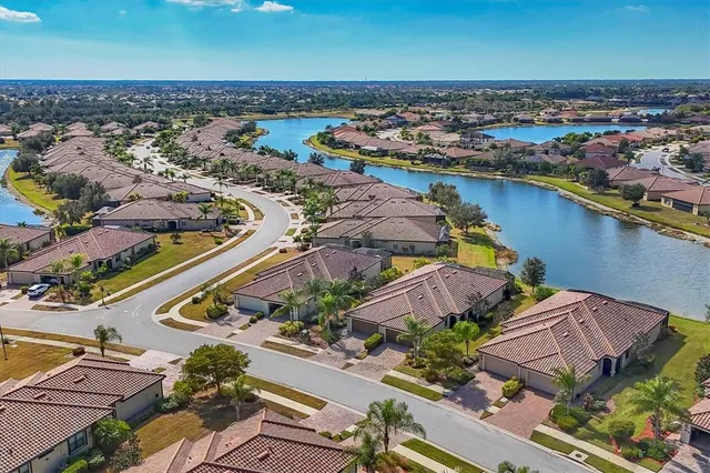 a front view of a house with a garden and potted plants
