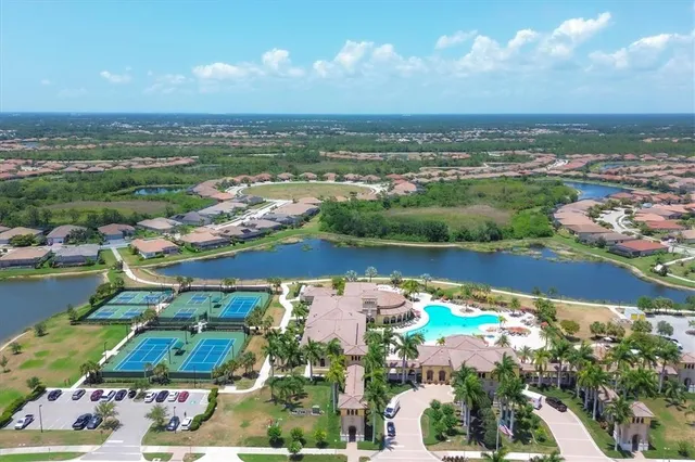 a view of a swimming pool with a patio and a garden