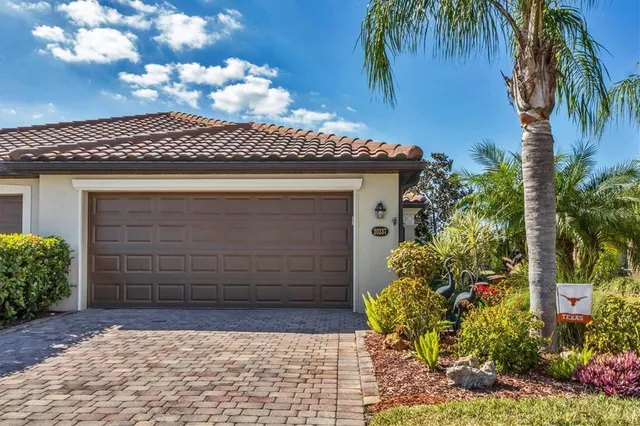 a view of a hallway with dining area window and wooden floor