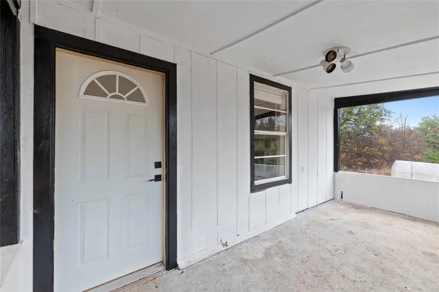 a bathroom with a large window and a bathtub