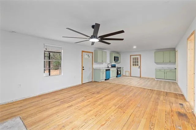a kitchen with a sink cabinets and wooden floor