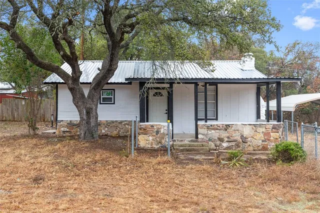 a front view of a house with table and chairs