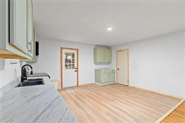 an empty room with a ceiling fan and wooden floor
