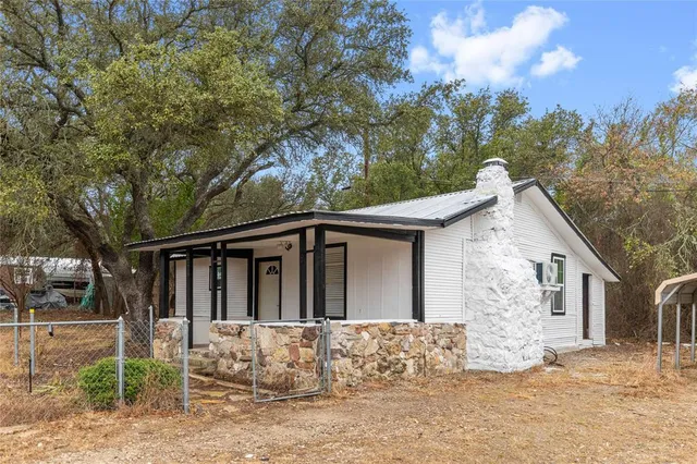 a view of house with a yard