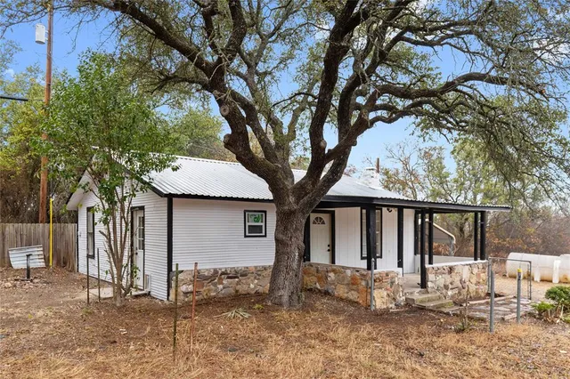a front view of house with yard and trees