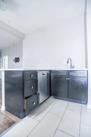 a kitchen with a refrigerator and cabinets