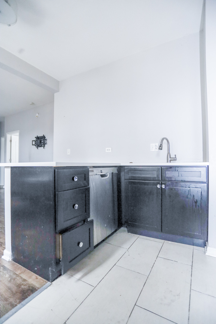 4400 North Magnolia Avenue, Unit 321 Chicago, IL 60640 - Photo 6 of 12 a kitchen with a refrigerator and cabinets
