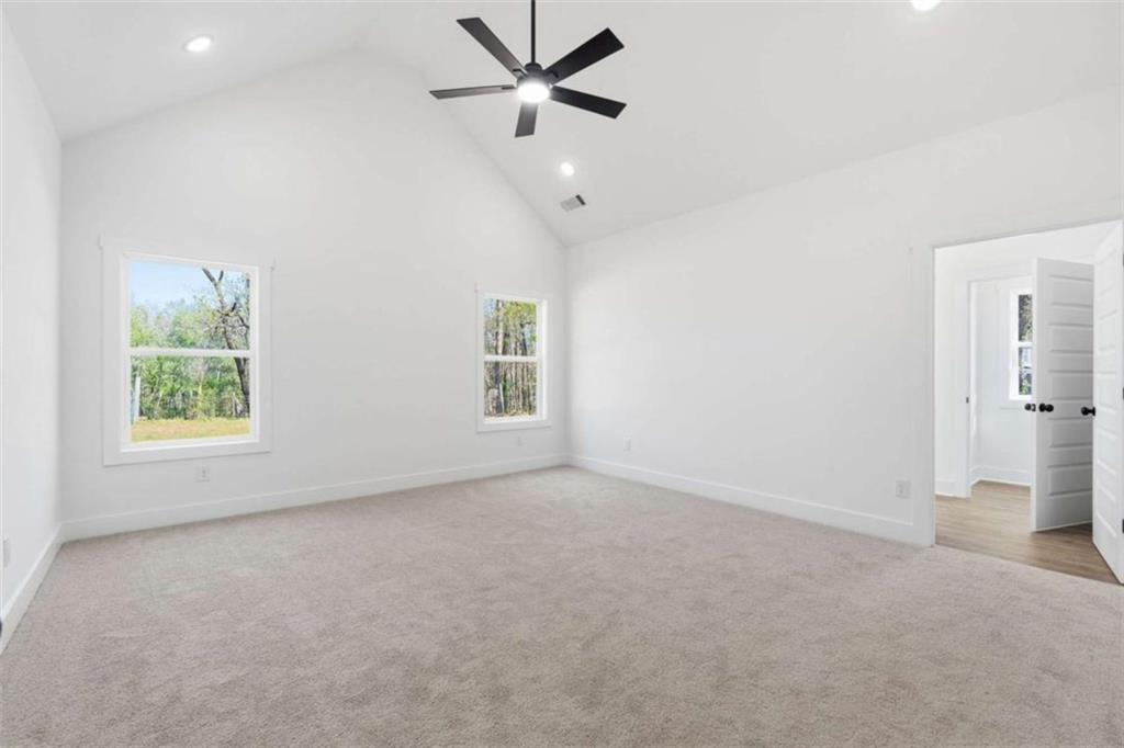 11691 Hazelbrand Road Northeast Covington, GA 30014 - Photo 32 of 53 an empty room with windows and fan