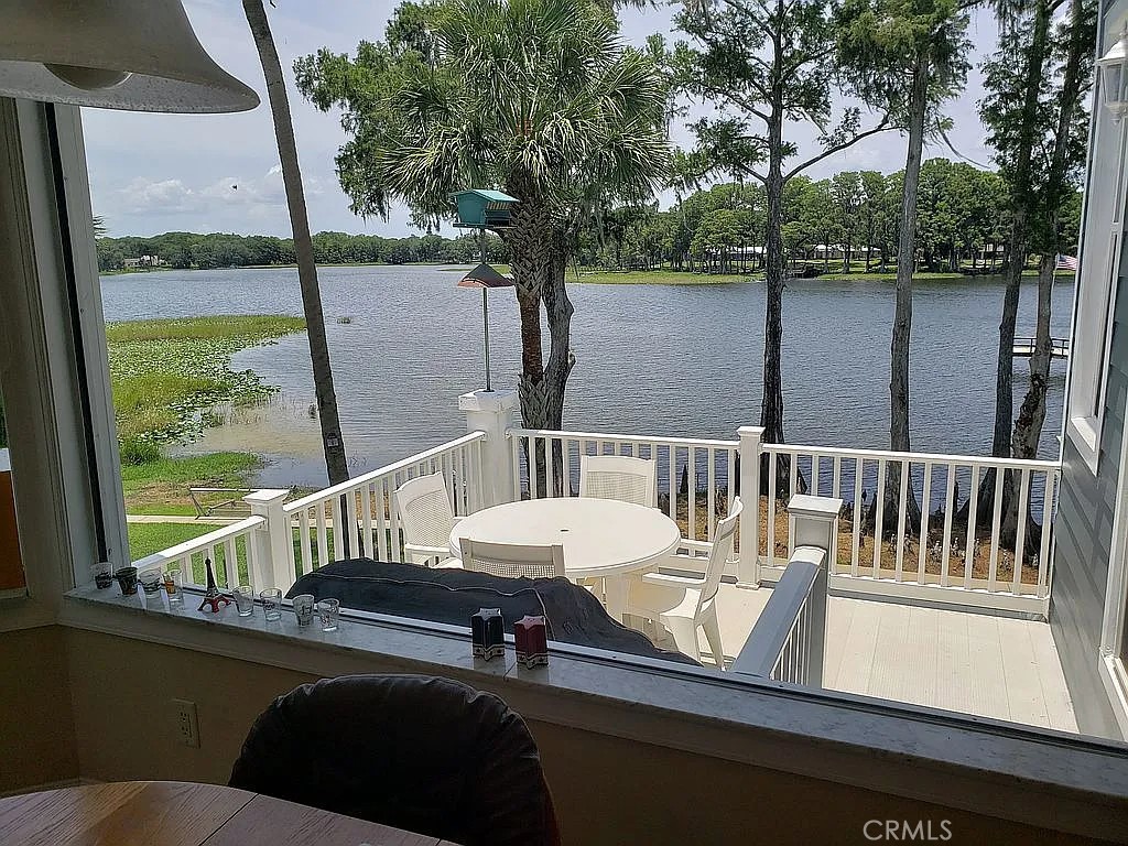 1360 South Waterview Drive Inverness, FL 34450 - Photo 21 of 34 a roof deck with table and chairs and wooden floor
