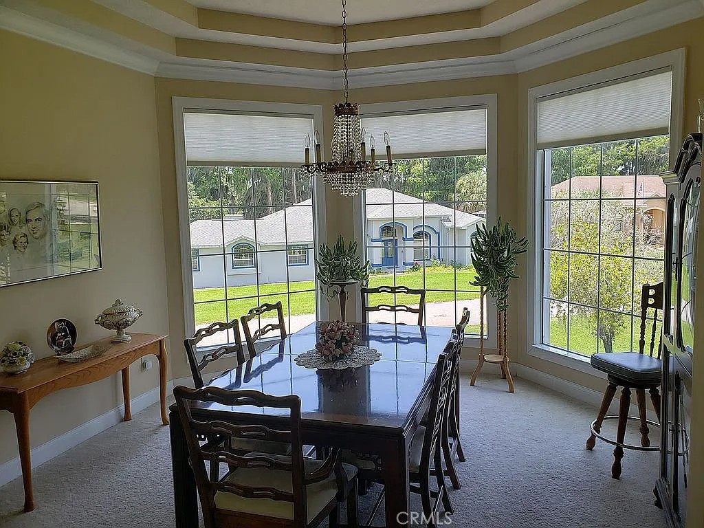 1360 South Waterview Drive Inverness, FL 34450 - Photo 22 of 34 a dining room with furniture a chandelier and wooden floor