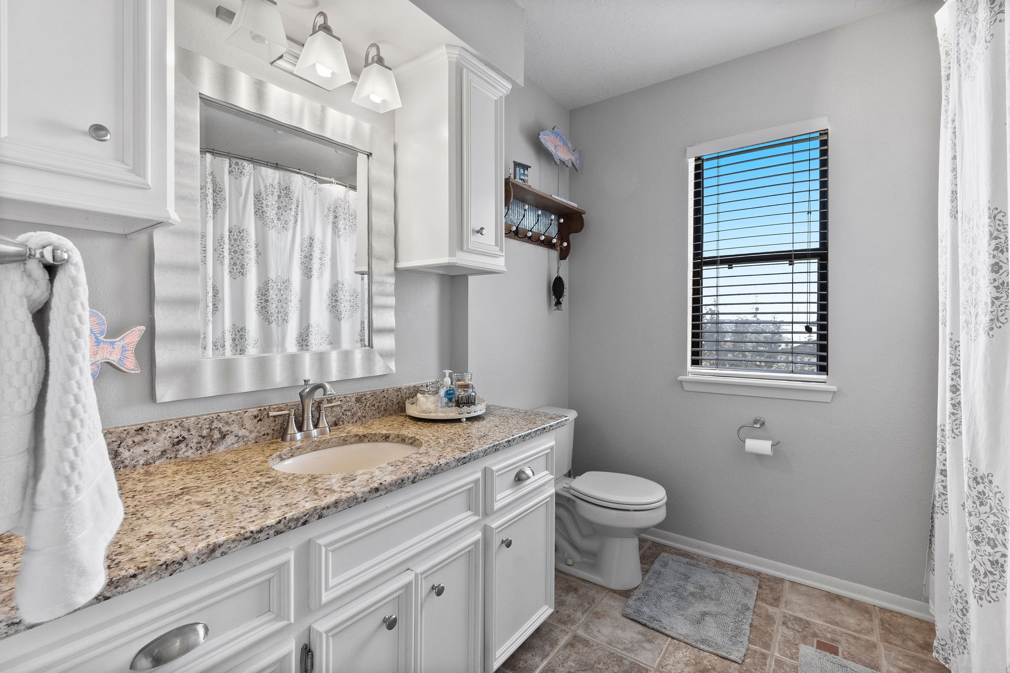 154 Point Drive Onalaska, TX 77360 - Photo 20 of 46 a bathroom with a granite countertop sink toilet and mirror