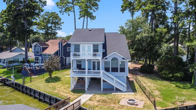 aerial view of a house with swimming pool lawn chairs and a yard