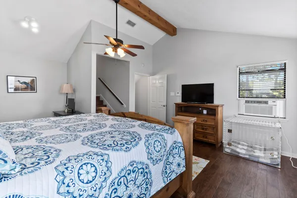 a bedroom with a bed and a flat screen tv