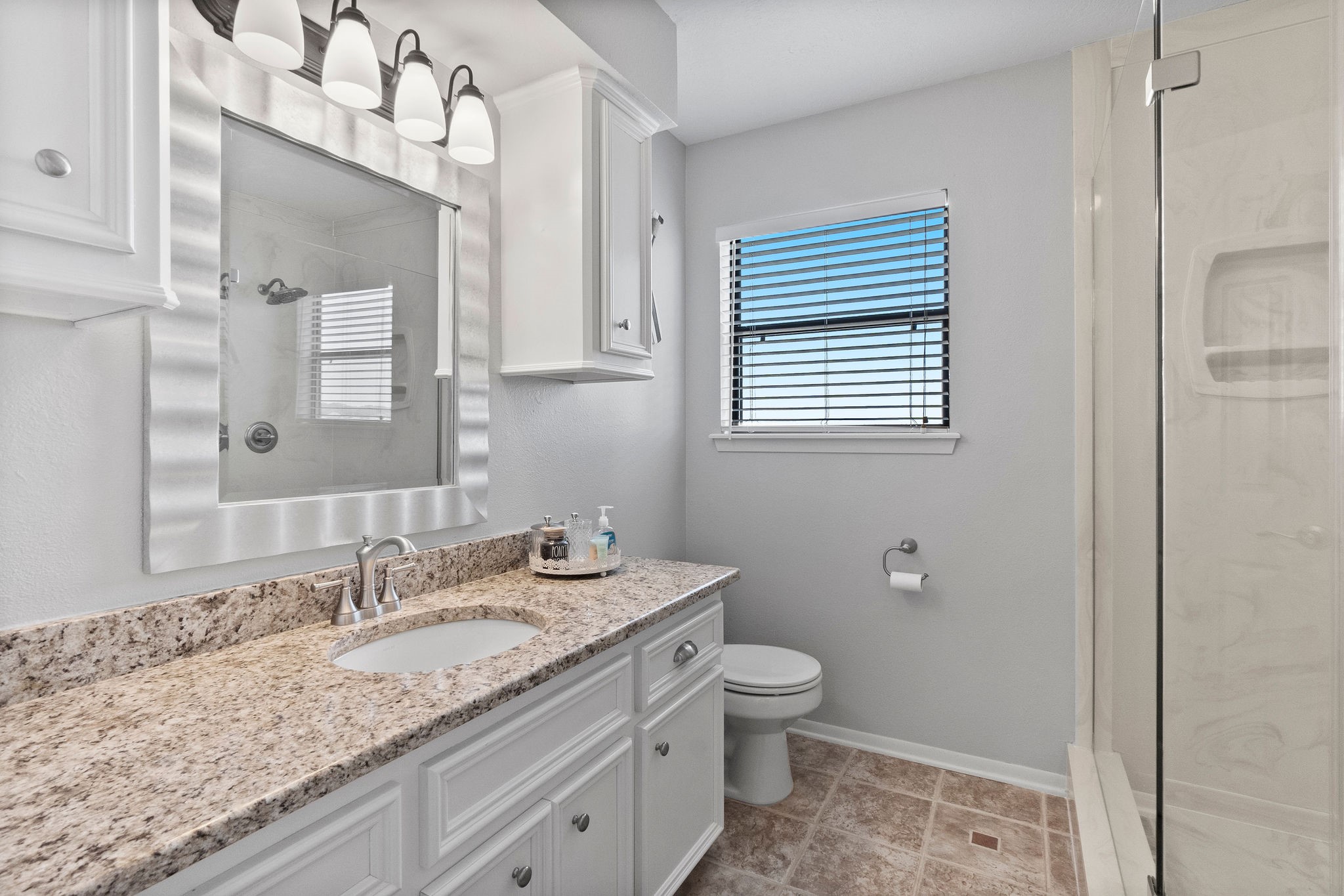 154 Point Drive Onalaska, TX 77360 - Photo 32 of 46 a bathroom with a granite countertop sink a toilet and mirror