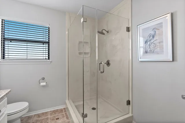 a bathroom with a shower toilet and sink