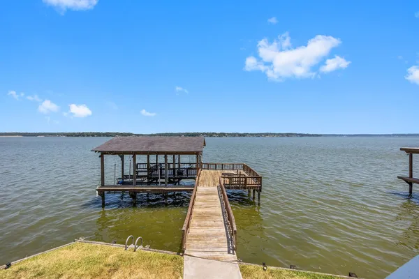 a view of a lake with couches in front of house