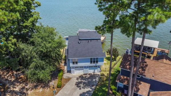 an aerial view of a house with a yard
