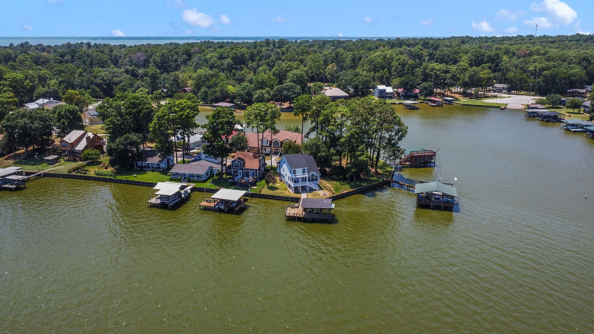 154 Point Drive Onalaska, TX 77360 - Photo 43 of 46 a view of a lake with boats and trees in the background