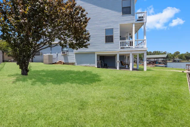 a view of a house with a yard and sitting area
